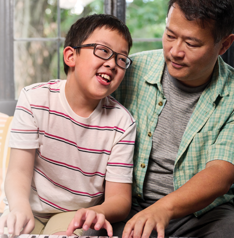 Sam, a 10-year-old living with NF1  PN, smiling with his dad